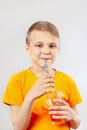 Little funny boy drinking fresh red lemonade through a straw Royalty Free Stock Photo