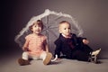 Little funny boy and girl under umbrella Royalty Free Stock Photo