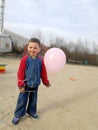 Little funny boy with pink balloon, smiles Royalty Free Stock Photo