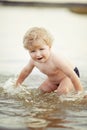 Little funny boy playing in lake Royalty Free Stock Photo