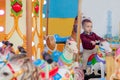 Little funny boy riding on the horse is a roundabout carousel in an amusement park. Happy child, having fun outdoors on a sunny da Royalty Free Stock Photo