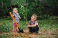 Little funny boy with shovel in garden Royalty Free Stock Photo