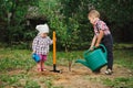 Little funny boy with shovel in garden Royalty Free Stock Photo