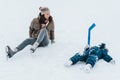 Little funny boy skating in the park and fell with his mother. Learn to Play ice hockey with stick. Outdoor. Winter Royalty Free Stock Photo