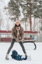 Little funny boy skating in the park and fell with his mother. Learn to Play ice hockey with stick. Outdoor. Winter Royalty Free Stock Photo