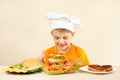 Little funny chef in chefs hat preparing hamburger Royalty Free Stock Photo