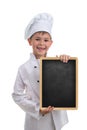 Little funny chef in white uniform holding a blackboard, on white background.