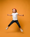 Little funny child baby girl jumping happy smiling laughing in white t-shirt with text copy space Royalty Free Stock Photo