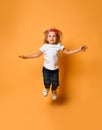 Little funny child baby girl jumping happy smiling laughing in white t-shirt with text copy space Royalty Free Stock Photo