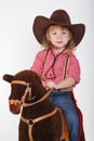 Little funny cowgirl riding horse Royalty Free Stock Photo