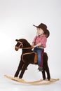 Little funny cowgirl riding horse Royalty Free Stock Photo