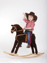 Little funny cowgirl riding horse Royalty Free Stock Photo