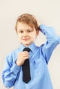 Little funny gentleman straighten tie over bright shirt Royalty Free Stock Photo