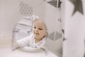 little funny girl brushing teeth and washing hands in the bathroom, reflection in the mirror. Royalty Free Stock Photo