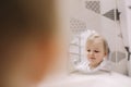 little funny girl brushing teeth and washing hands in the bathroom, reflection in the mirror. Royalty Free Stock Photo