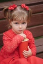 Little girl with cup of popcorn in park Royalty Free Stock Photo