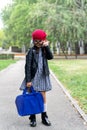 A little funny girl in a red cap and a briefcase goes to school Royalty Free Stock Photo