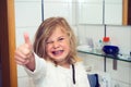 Little funny girl with retainer and thumb up