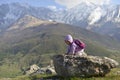 A little girl travels in the mountains.