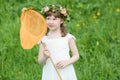Little funny girl in white looks at butterfly