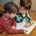 Little genius boy help his brother with homework