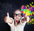 Little genius girl on chalk board in classroom with symbol