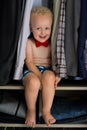 Little gentleman is getting ready. Cute and shy boy with curly b Royalty Free Stock Photo