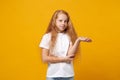 Little ginger kid girl 12-13 years old wearing white t-shirt isolated on bright yellow wall background children studio Royalty Free Stock Photo