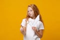 Little ginger kid girl 12-13 years old in white t-shirt isolated on yellow wall background children studio portrait Royalty Free Stock Photo