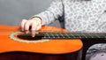 Little girl and acoustic guitar. child learn to play the guitar