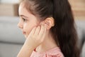 Little girl adjusting hearing aid Royalty Free Stock Photo