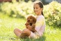 a little girl with Adorable Maltese and Poodle mix Puppy or Maltipoo dog