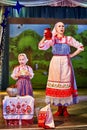 A little girl and an adult woman in Russian national dress rehearsing on stage. Mother and daughter sing and dance together Royalty Free Stock Photo