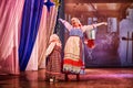 A little girl and an adult woman in Russian national dress rehearsing on stage. Mother and daughter sing and dance together Royalty Free Stock Photo