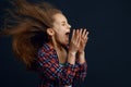 Little girl against powerful airflow in studio