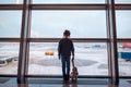Little girl in airport near big window while wait for boarding Royalty Free Stock Photo