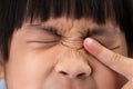 Little girl allergic to dust rubs her eyes close-up. Little girl itchy his eyes with tear Royalty Free Stock Photo