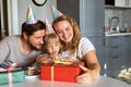 Little girl in anticipation of receiving, unpacking gifts from parents Royalty Free Stock Photo