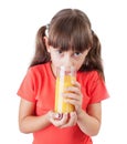 Little girl with an appetite drinking juice Royalty Free Stock Photo