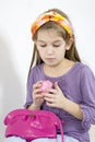 Little girl applying make-up with powder-puff Royalty Free Stock Photo