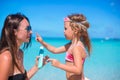 Little girl applying sunblock cream on her mom Royalty Free Stock Photo