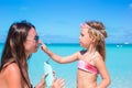 Little girl applying sunblock cream on her mom Royalty Free Stock Photo