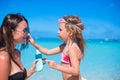 Little girl applying sunblock cream on her mom Royalty Free Stock Photo