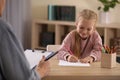 Little girl on appointment with child psychotherapist Royalty Free Stock Photo