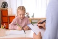 Little girl on appointment with child psychotherapist Royalty Free Stock Photo