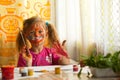 Little girl artist with paint of face. Royalty Free Stock Photo