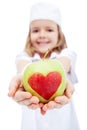 Little girl as nurse giving you an apple Royalty Free Stock Photo