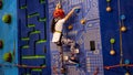 Little girl ascending in rock climbing gym Royalty Free Stock Photo