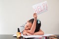 Little girl asking help with a sheet of paper. Concept of bored schoolchild doing homework at home during the quarantine of virus Royalty Free Stock Photo