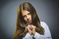 Little girl with astonished expression while standing against grey background Royalty Free Stock Photo